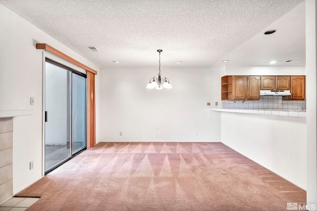 interior space featuring a textured ceiling and an inviting chandelier