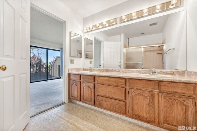 bathroom with vanity and an enclosed shower