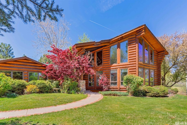 log-style house featuring a front yard