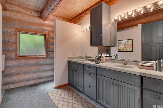 bathroom with beamed ceiling, dual vanity, rustic walls, and wood ceiling