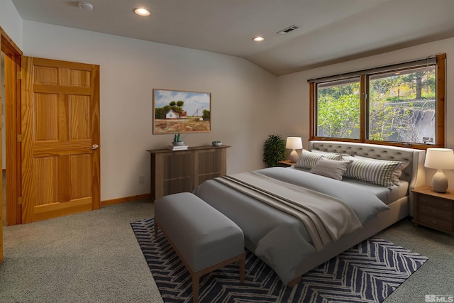 carpeted bedroom with lofted ceiling