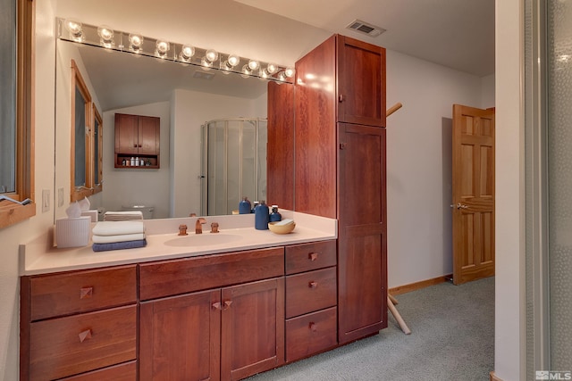 bathroom featuring vanity with extensive cabinet space and toilet