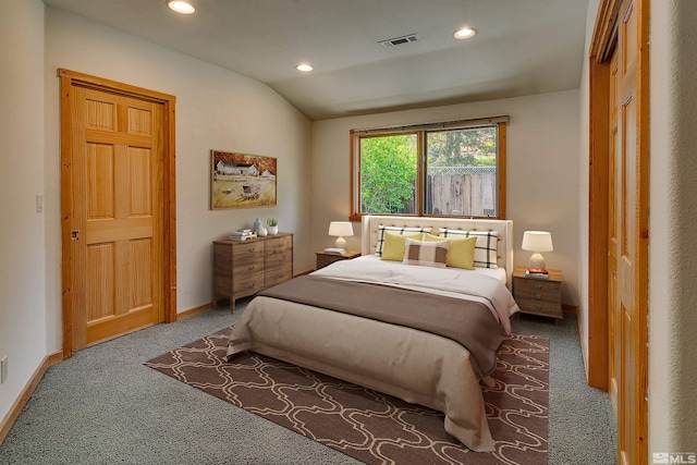 carpeted bedroom featuring a closet and vaulted ceiling