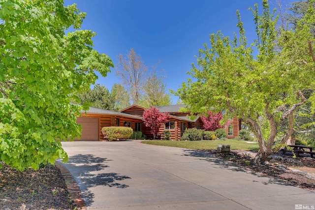 log-style house featuring a garage