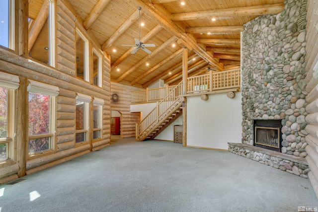 unfurnished living room featuring carpet, rustic walls, and wooden ceiling