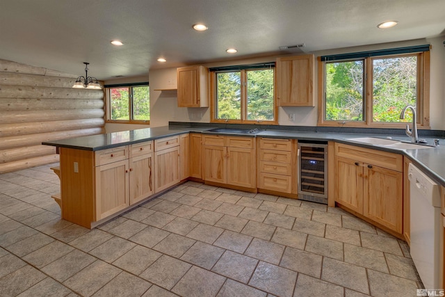 kitchen featuring beverage cooler, white dishwasher, sink, light tile floors, and pendant lighting