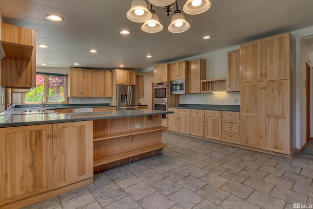 kitchen featuring dark stone counters, an inviting chandelier, light tile floors, sink, and appliances with stainless steel finishes