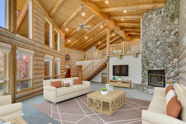 living room with a fireplace, high vaulted ceiling, log walls, and wood ceiling