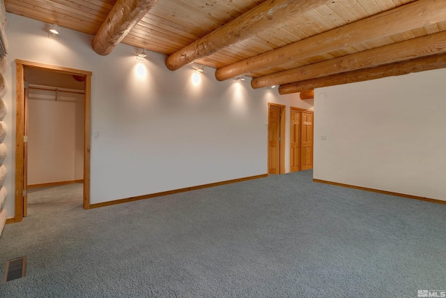 carpeted spare room with beamed ceiling and wooden ceiling