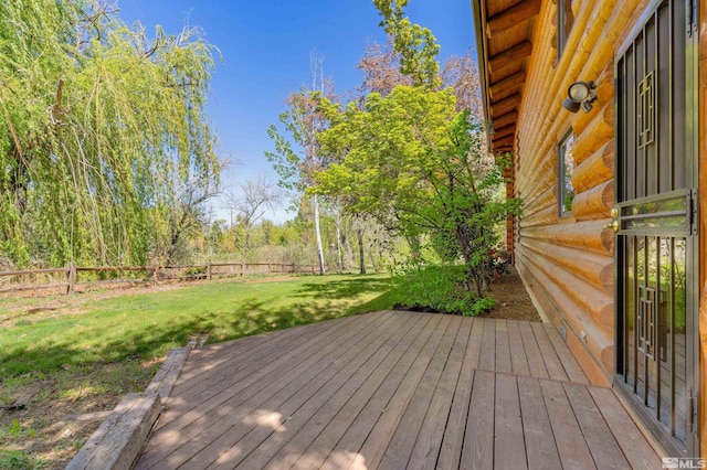 wooden terrace with a yard