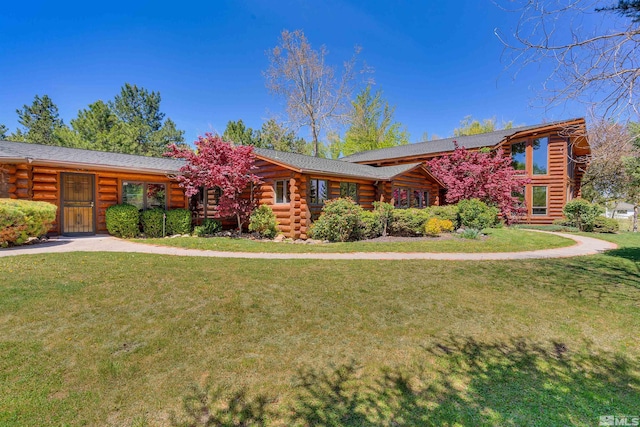 cabin featuring a front lawn