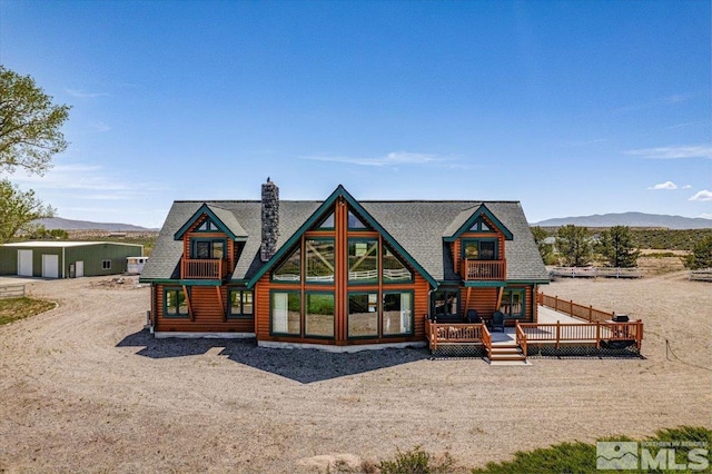 view of front facade with a deck with mountain view