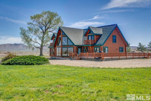 rear view of property featuring a lawn