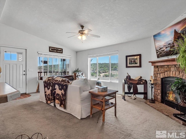 living room with ceiling fan, carpet floors, and a fireplace