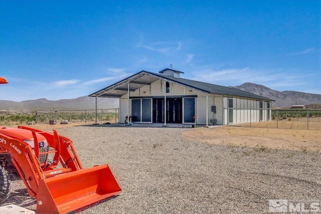 back of property with a mountain view