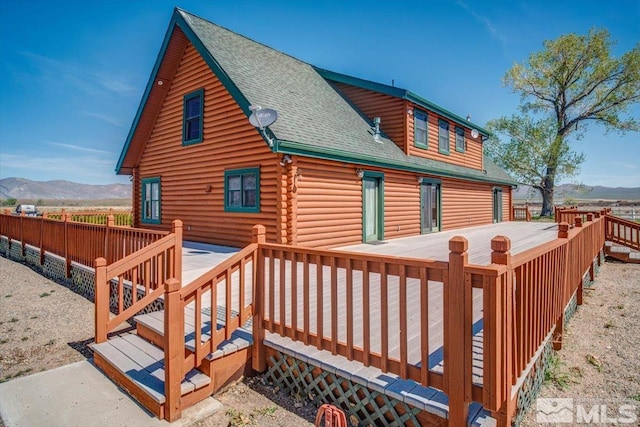 exterior space featuring a deck with mountain view