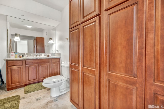 bathroom featuring tile flooring, oversized vanity, and toilet