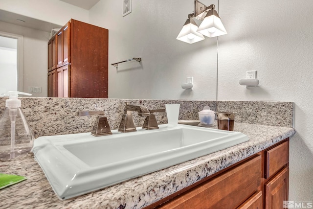 bathroom featuring vanity and tasteful backsplash