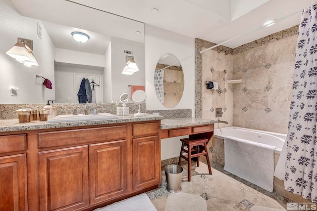 bathroom featuring tile floors, a bathtub, and vanity