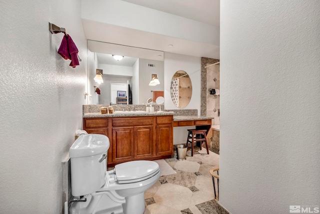 bathroom featuring tile floors, large vanity, and toilet