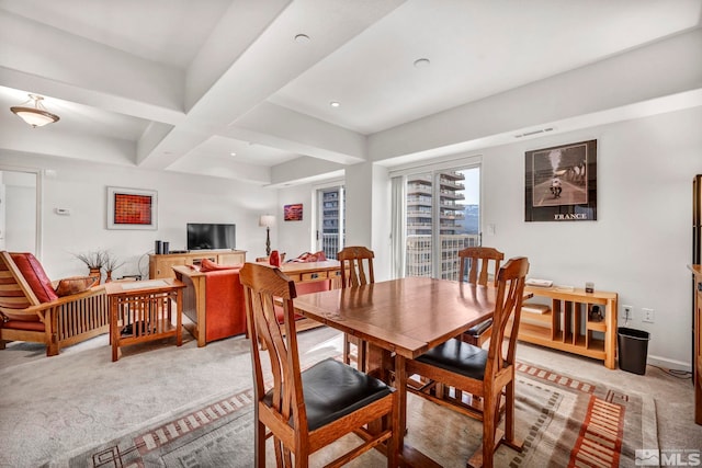 carpeted dining area with beam ceiling and coffered ceiling