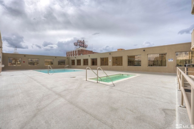 view of swimming pool featuring a patio area