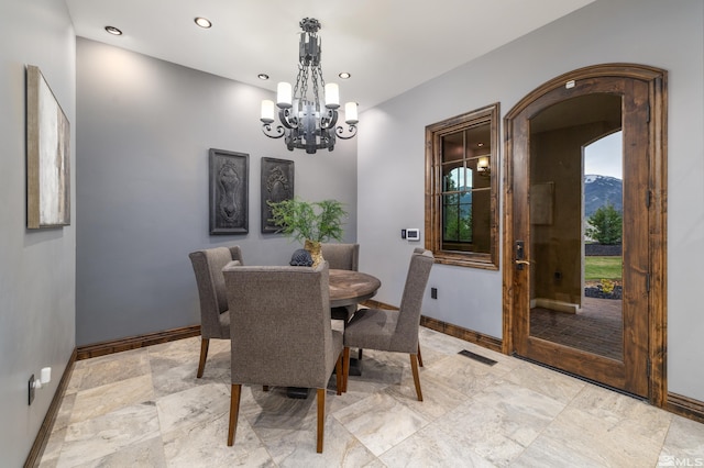 tiled dining area with a mountain view and an inviting chandelier