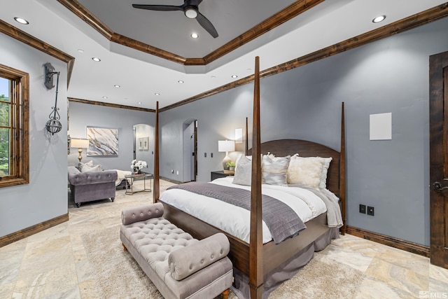 bedroom featuring crown molding, tile flooring, ceiling fan, and a raised ceiling