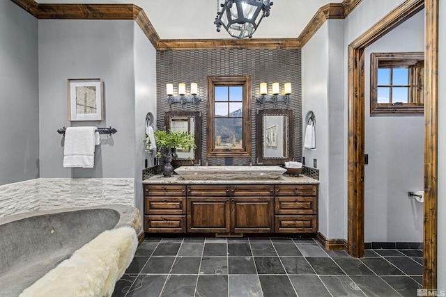 bathroom with tile floors, plenty of natural light, vanity, and a tub