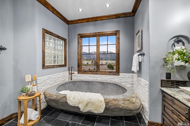 bathroom with tile flooring, vanity, crown molding, and a bathing tub