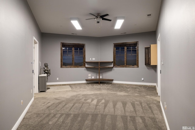 interior space with carpet and ceiling fan