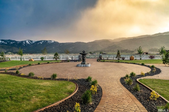 surrounding community featuring a yard and a mountain view