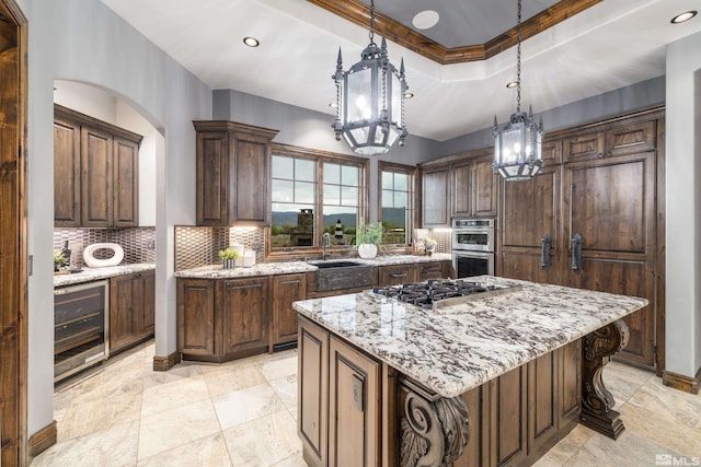 kitchen with hanging light fixtures, tasteful backsplash, wine cooler, a center island, and light tile floors