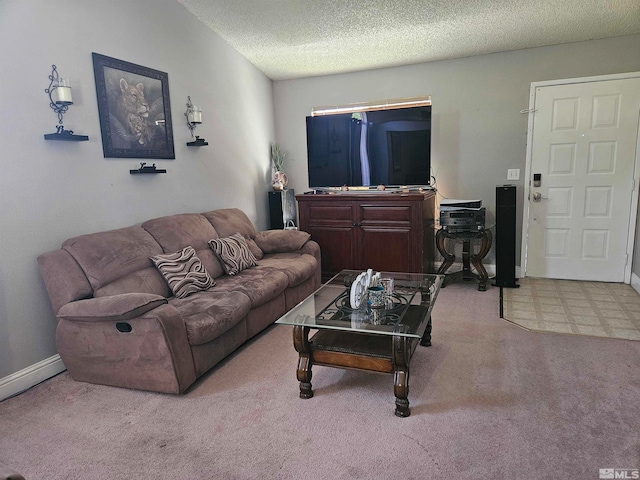 living room featuring light colored carpet and a textured ceiling