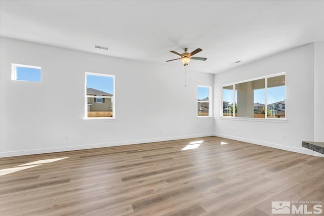 unfurnished room with ceiling fan, light hardwood / wood-style flooring, and plenty of natural light