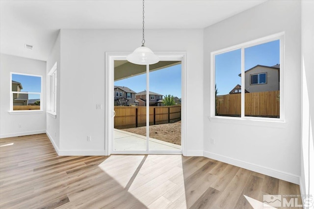 unfurnished dining area featuring light hardwood / wood-style floors