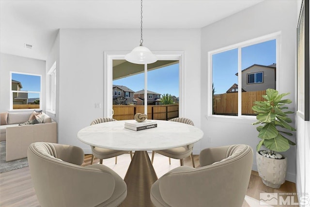 dining area with light hardwood / wood-style flooring