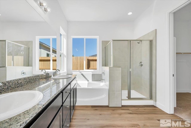 bathroom with shower with separate bathtub, hardwood / wood-style floors, and vanity