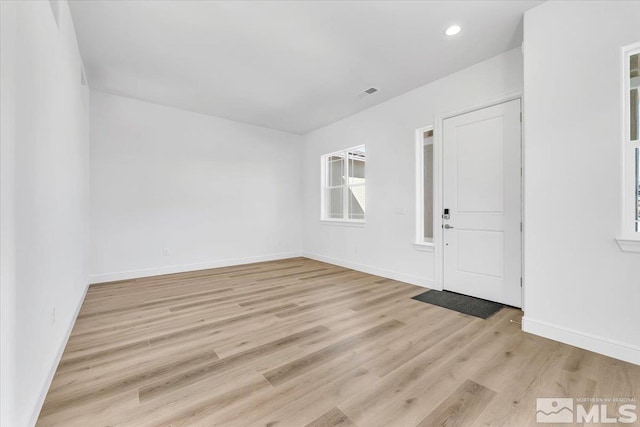 spare room with light wood-type flooring