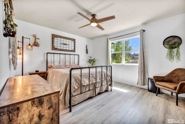 bedroom with ceiling fan and light hardwood / wood-style flooring