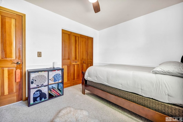 bedroom featuring a closet, ceiling fan, and light colored carpet