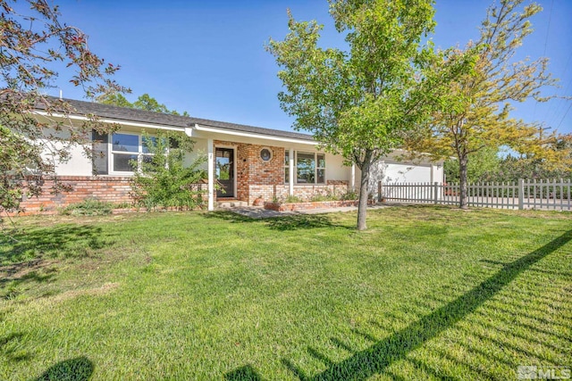 ranch-style home featuring a front yard