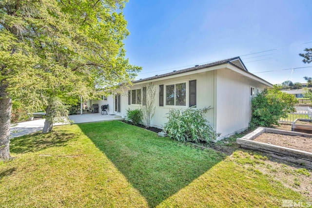 exterior space with a front yard and a patio