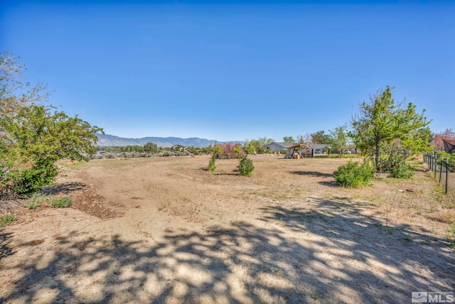 view of yard featuring a rural view and a mountain view