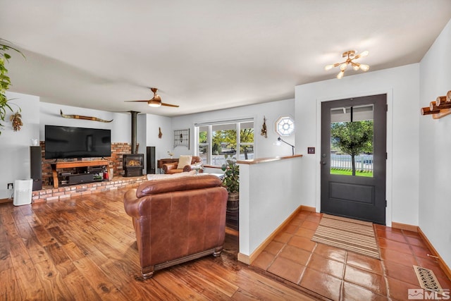 foyer entrance with hardwood / wood-style flooring and ceiling fan with notable chandelier