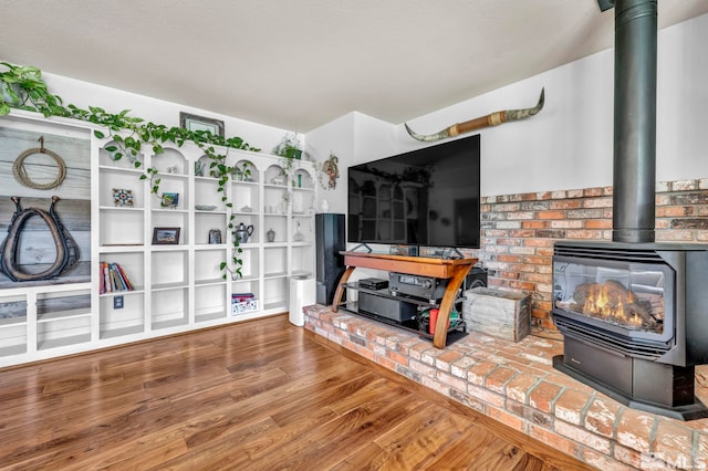 living room with hardwood / wood-style flooring and a wood stove