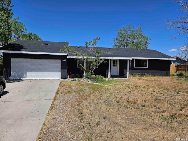 ranch-style house featuring a front yard and a garage