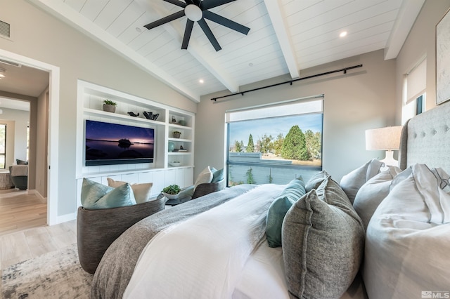 bedroom with vaulted ceiling with beams, hardwood / wood-style floors, ceiling fan, and multiple windows