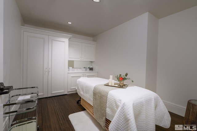 bedroom with dark hardwood / wood-style flooring