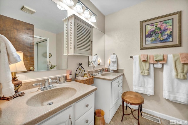 bathroom featuring tile patterned flooring and vanity